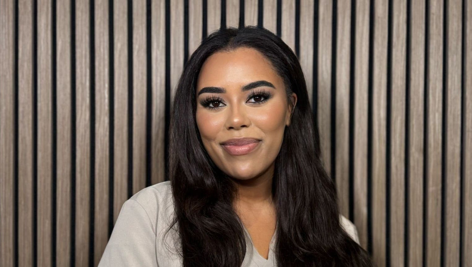 Smiling woman at India Brown Aesthetics & Beauty (CROYDON), Addiscombe, showcasing elegant makeup.