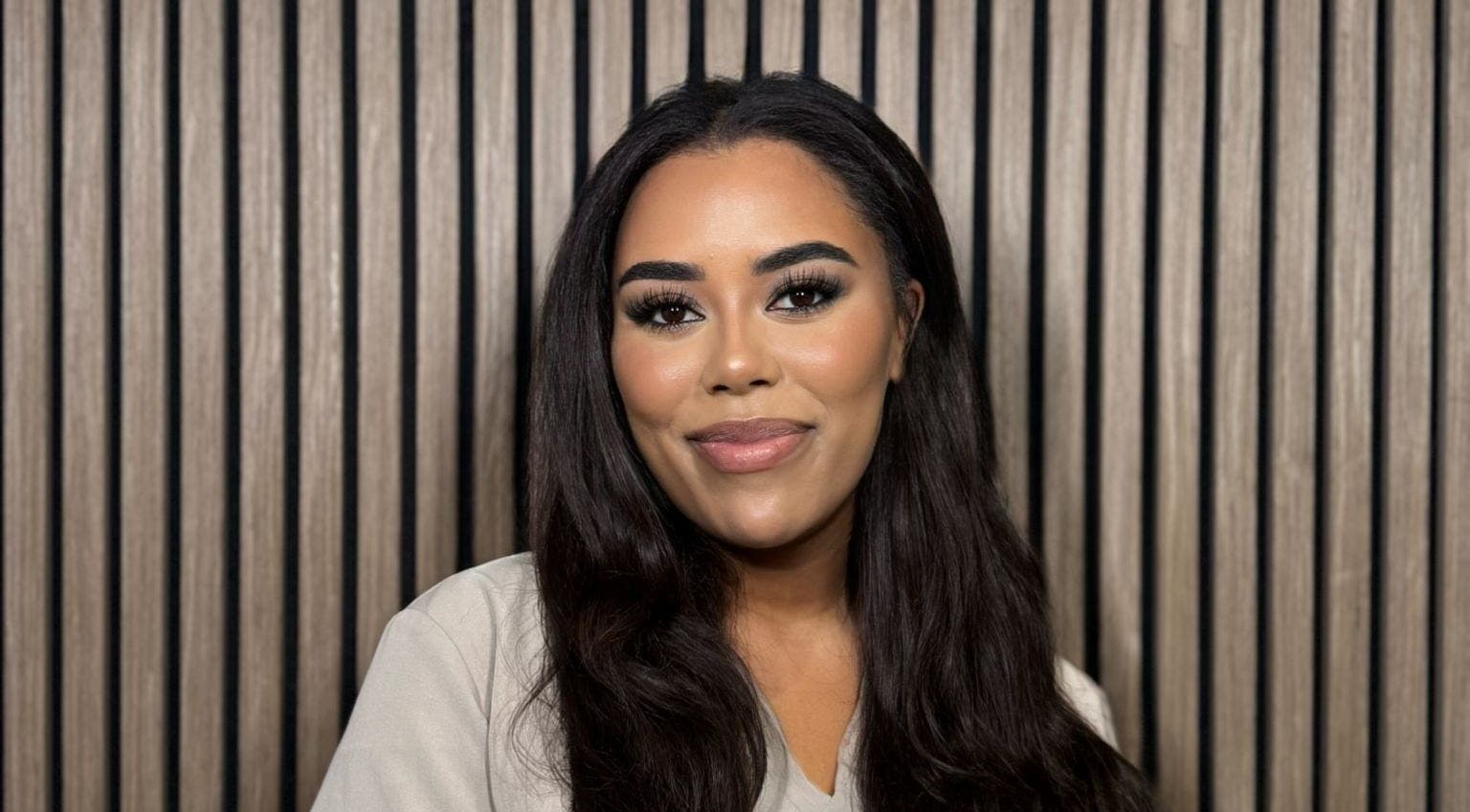 Smiling woman at India Brown Aesthetics & Beauty (CROYDON), Addiscombe, showcasing elegant makeup.