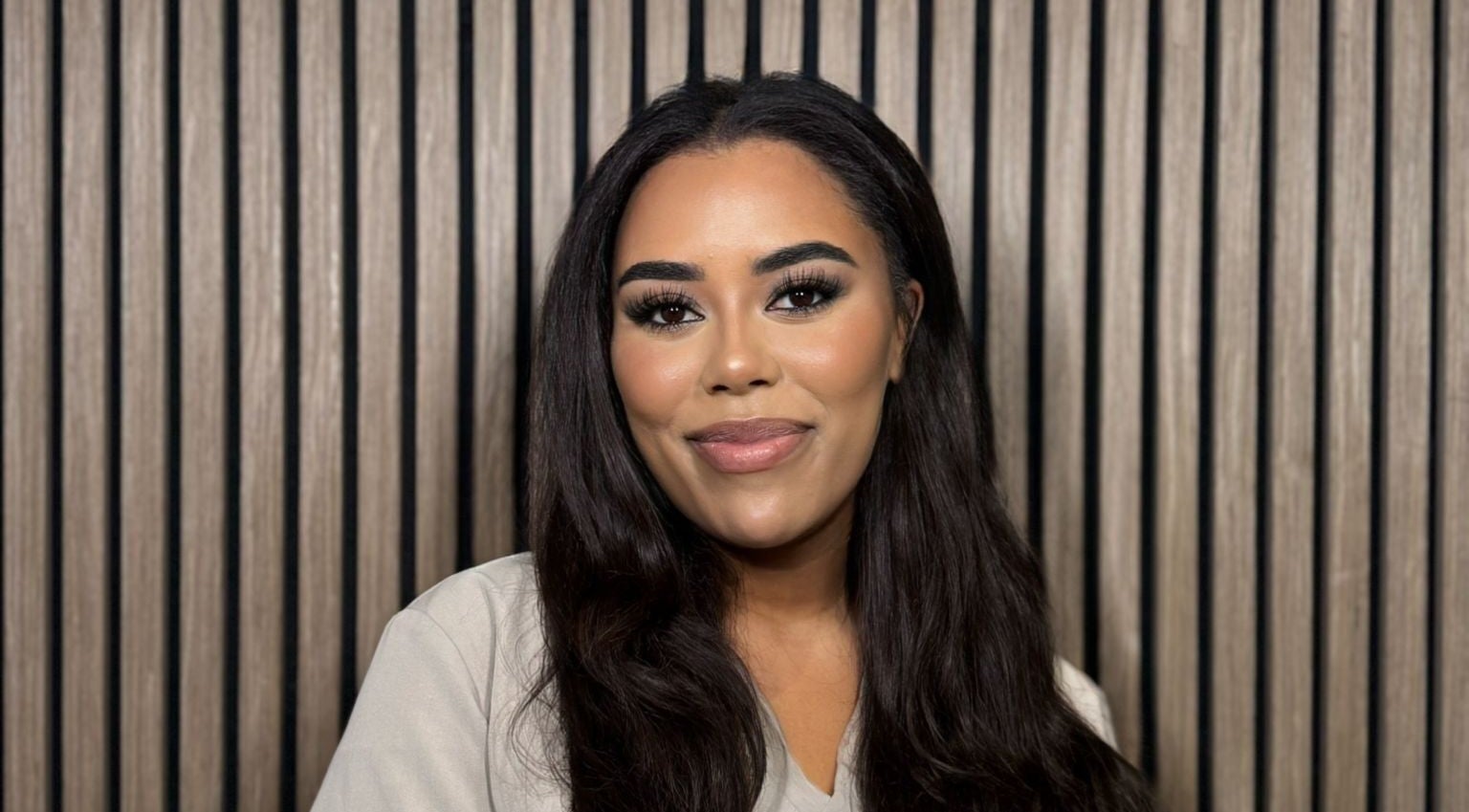 Smiling woman at India Brown Aesthetics & Beauty (CROYDON), Addiscombe, showcasing elegant makeup.