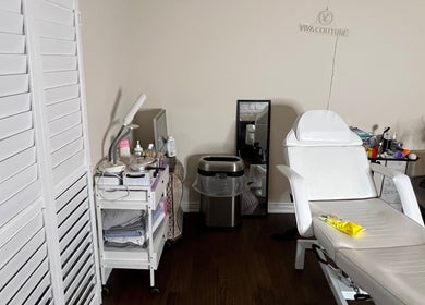 Relaxing treatment room at Nyeyeview, Hamilton, Ontario, CA with white chair and spa equipment.