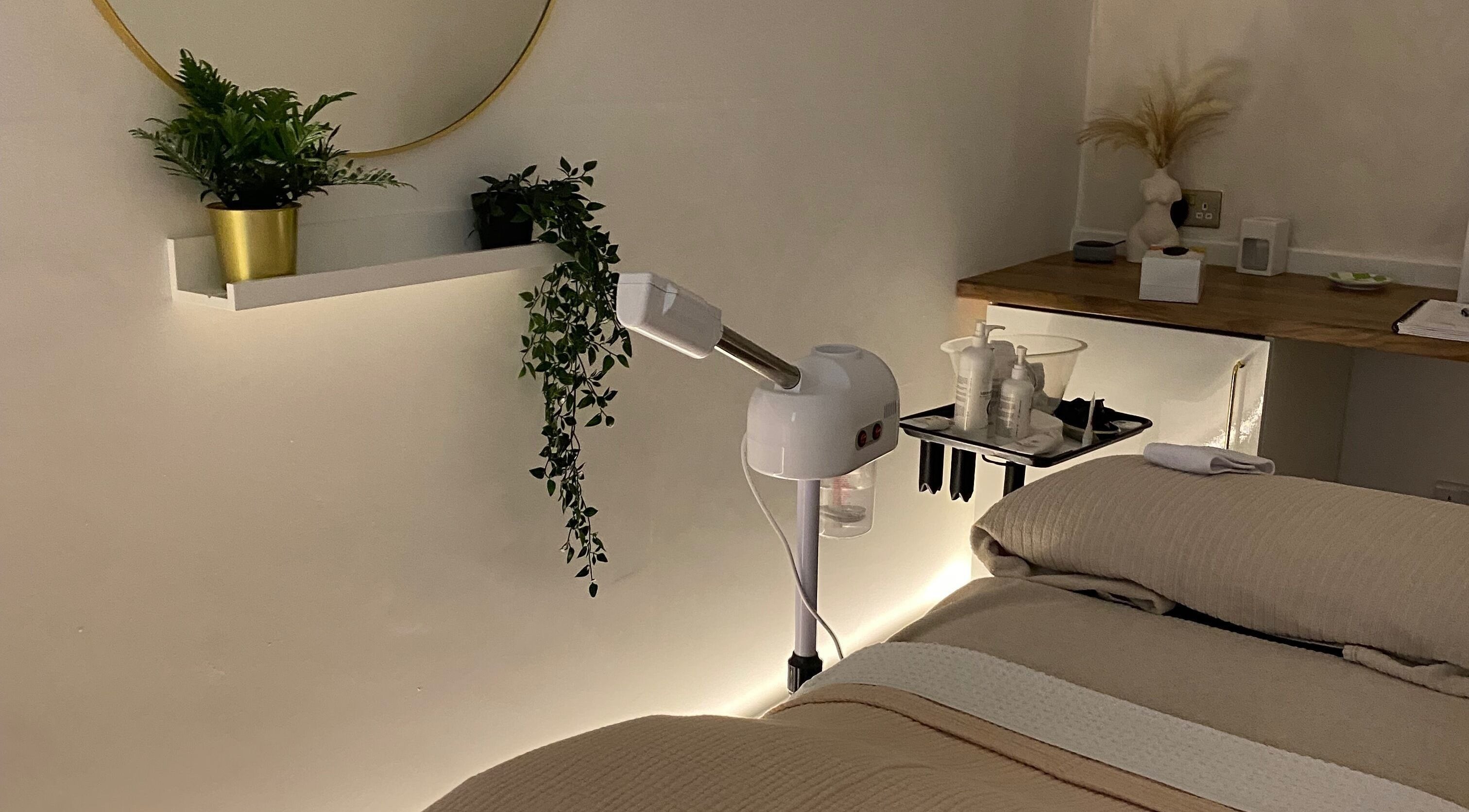 Calm treatment room at Hunt Skincare, Eastbourne, England, GB with plants and skincare equipment.