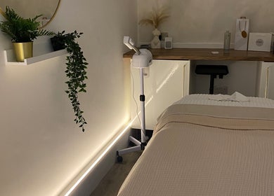 Elegant treatment room at Hunt. Skincare in Eastbourne, England, GB, featuring a cozy massage bed and stylish decor.
