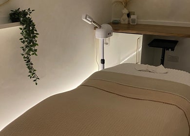 Serene treatment room at Hunt. Skincare in Eastbourne, England, GB with a cozy massage bed and ambient lighting.