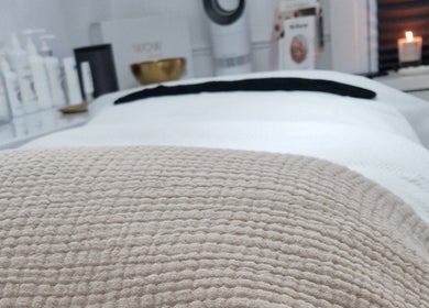 Relaxing treatment room at Reform Skin Clinic in Cawood, England, GB, showcasing cozy ambiance and skincare products.