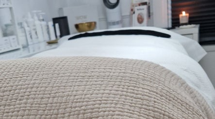 Relaxing treatment room at Reform Skin Clinic in Cawood, England, GB, showcasing cozy ambiance and skincare products.