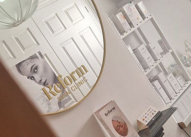 Elegant mirror branding at Reform Skin Clinic in Cawood, England, GB with product shelves visible.