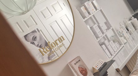 Elegant mirror branding at Reform Skin Clinic in Cawood, England, GB with product shelves visible.