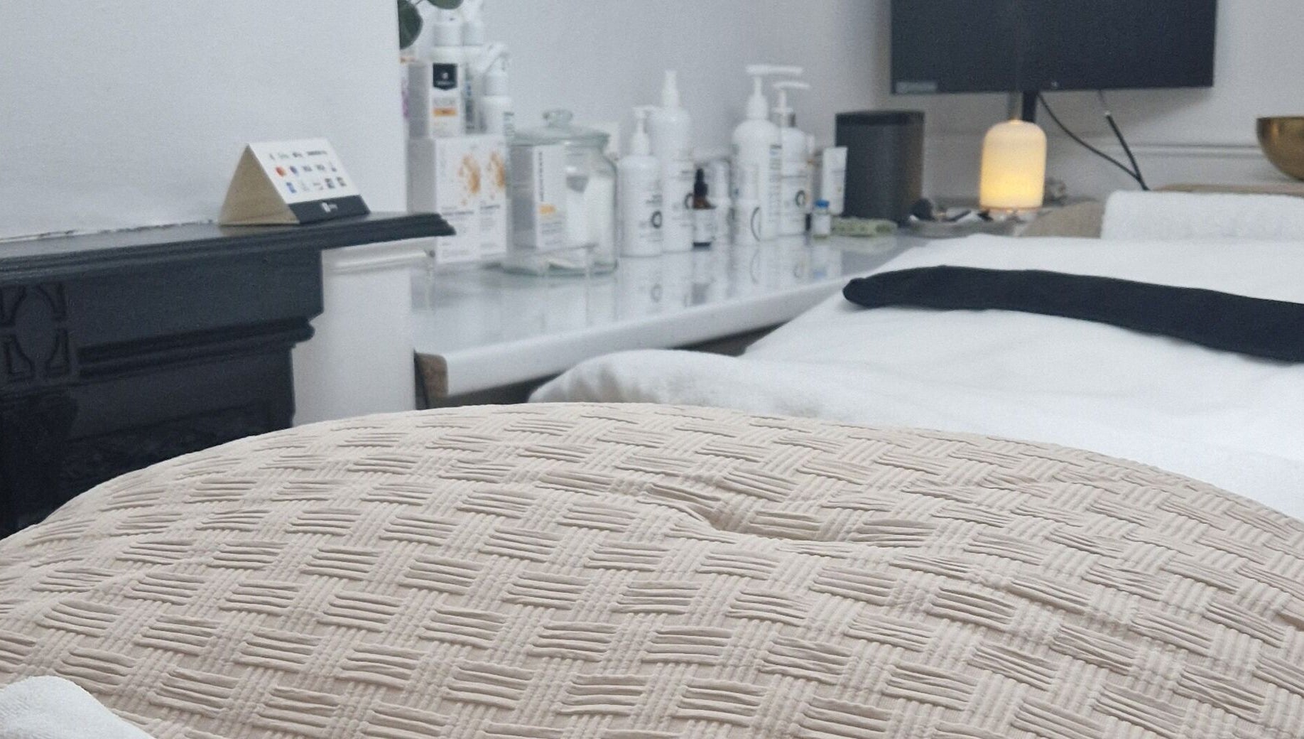 Relaxing treatment room at Reform Skin Clinic, Cawood, England, GB, featuring a plush bed and skincare products.