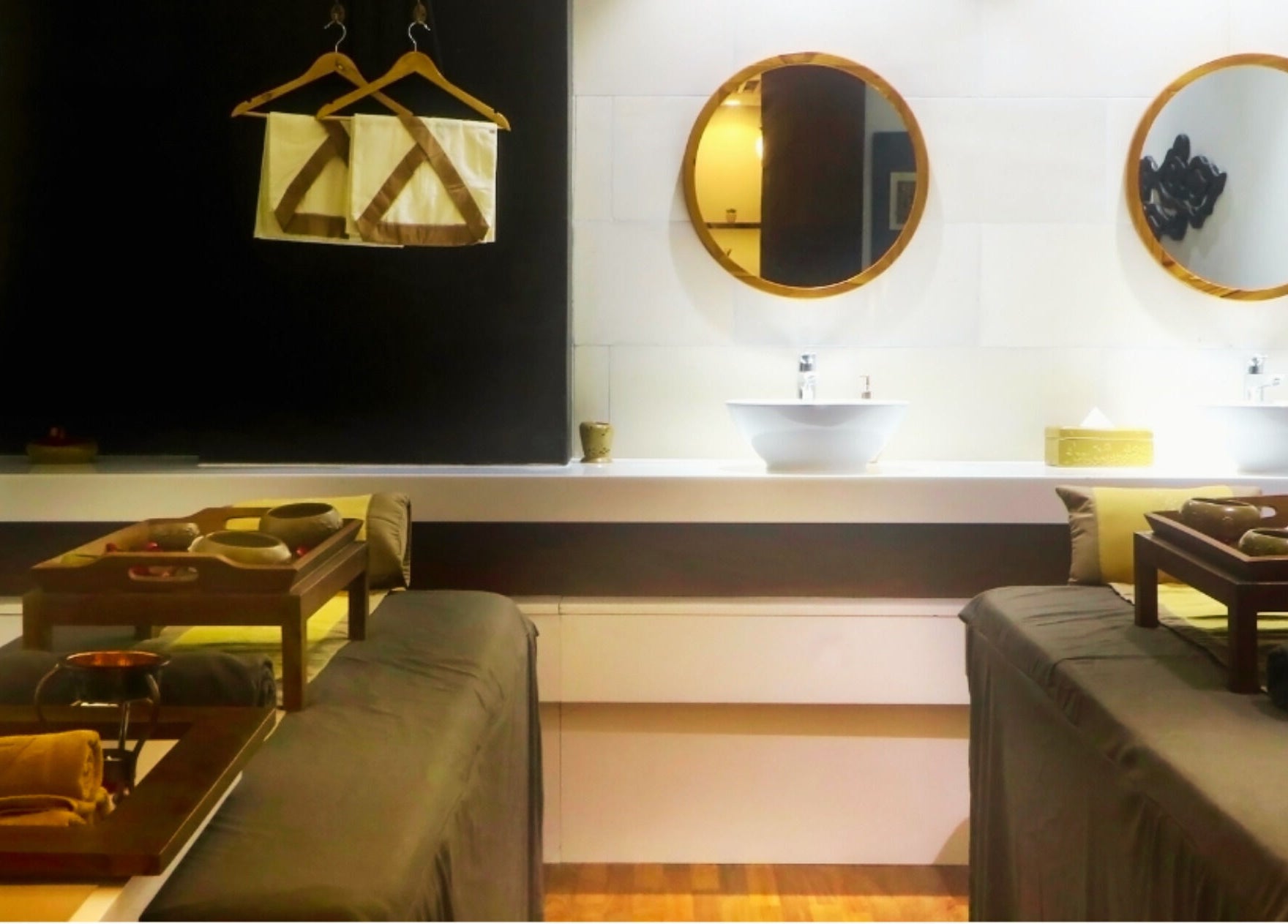 Elegant treatment room at Martha Tilaar Spa Colombo, Western Province, LK, featuring dual massage tables and warm lighting.