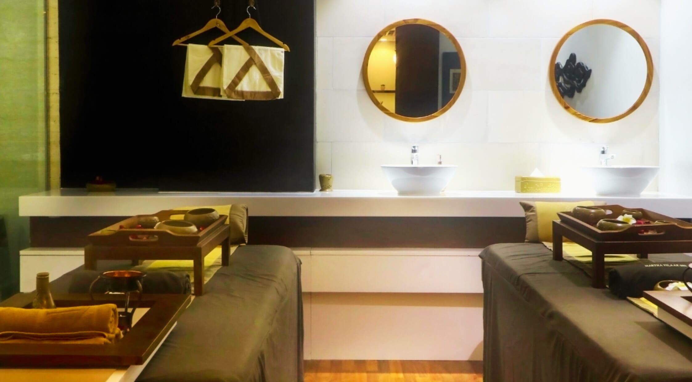 Elegant treatment room at Martha Tilaar Spa Colombo, Western Province, LK, featuring dual massage tables and warm lighting.
