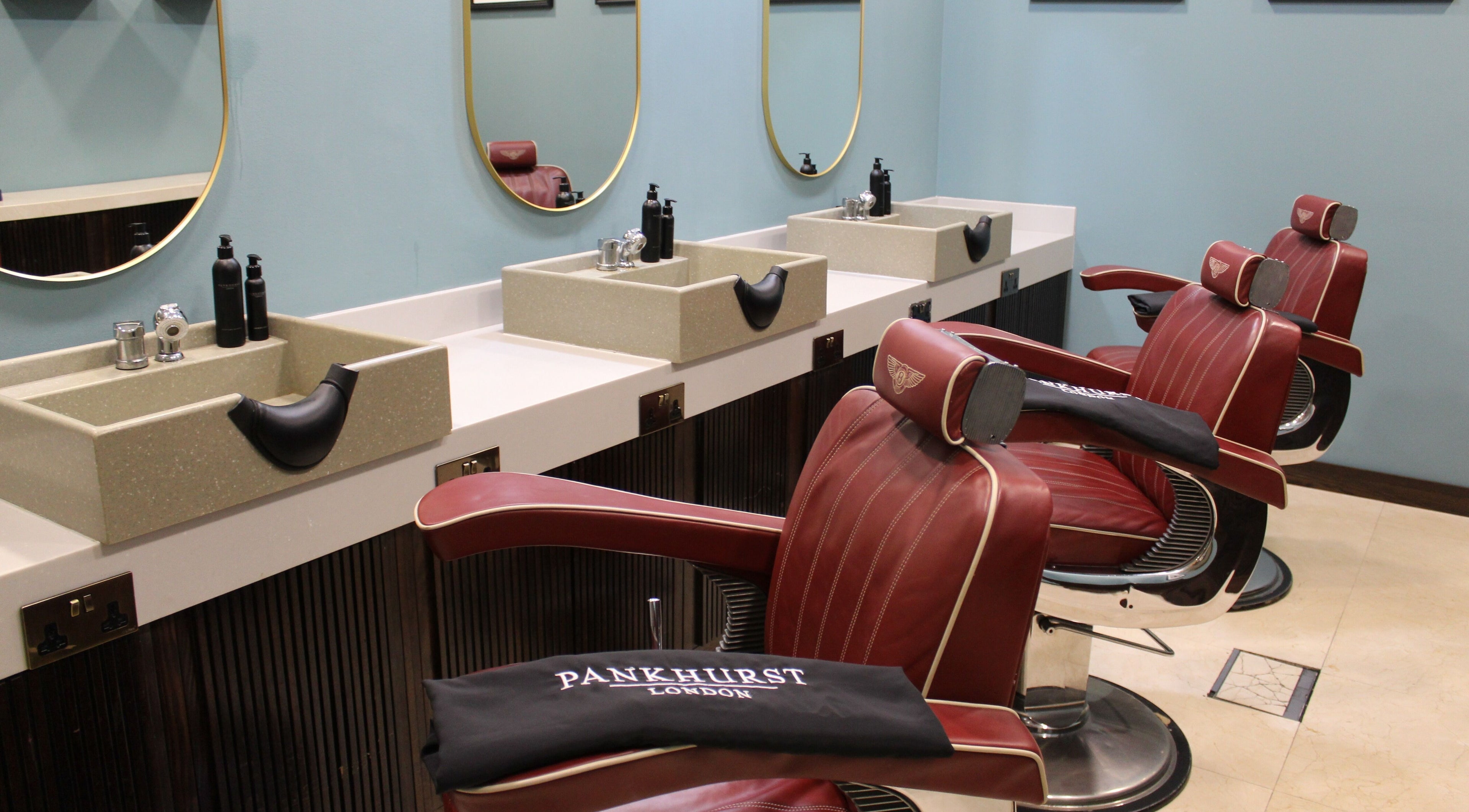 Stylish barber chairs at Pankhurst London, Dubai, Dubai, AE, showcasing luxury grooming ambiance.