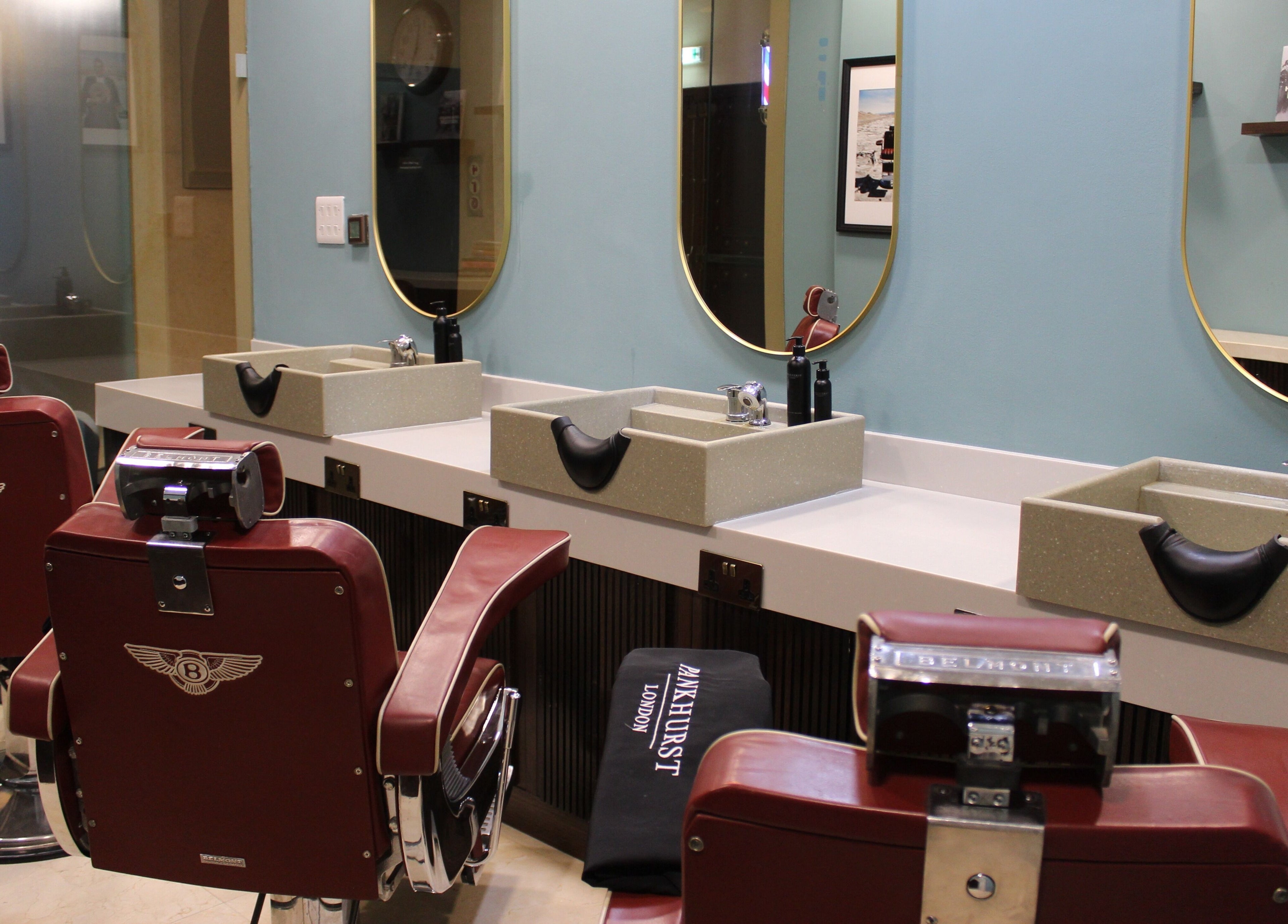 Stylish barber chairs and sinks at Pankhurst London located in Dubai, Dubai, AE.