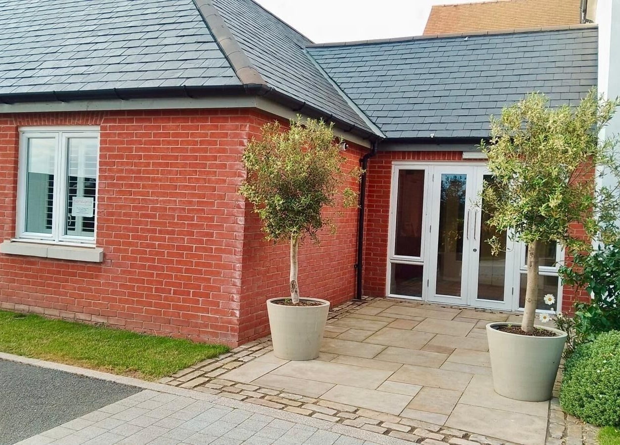 Gifford Lea entrance with red brick exterior and potted trees in Chester, England, GB.