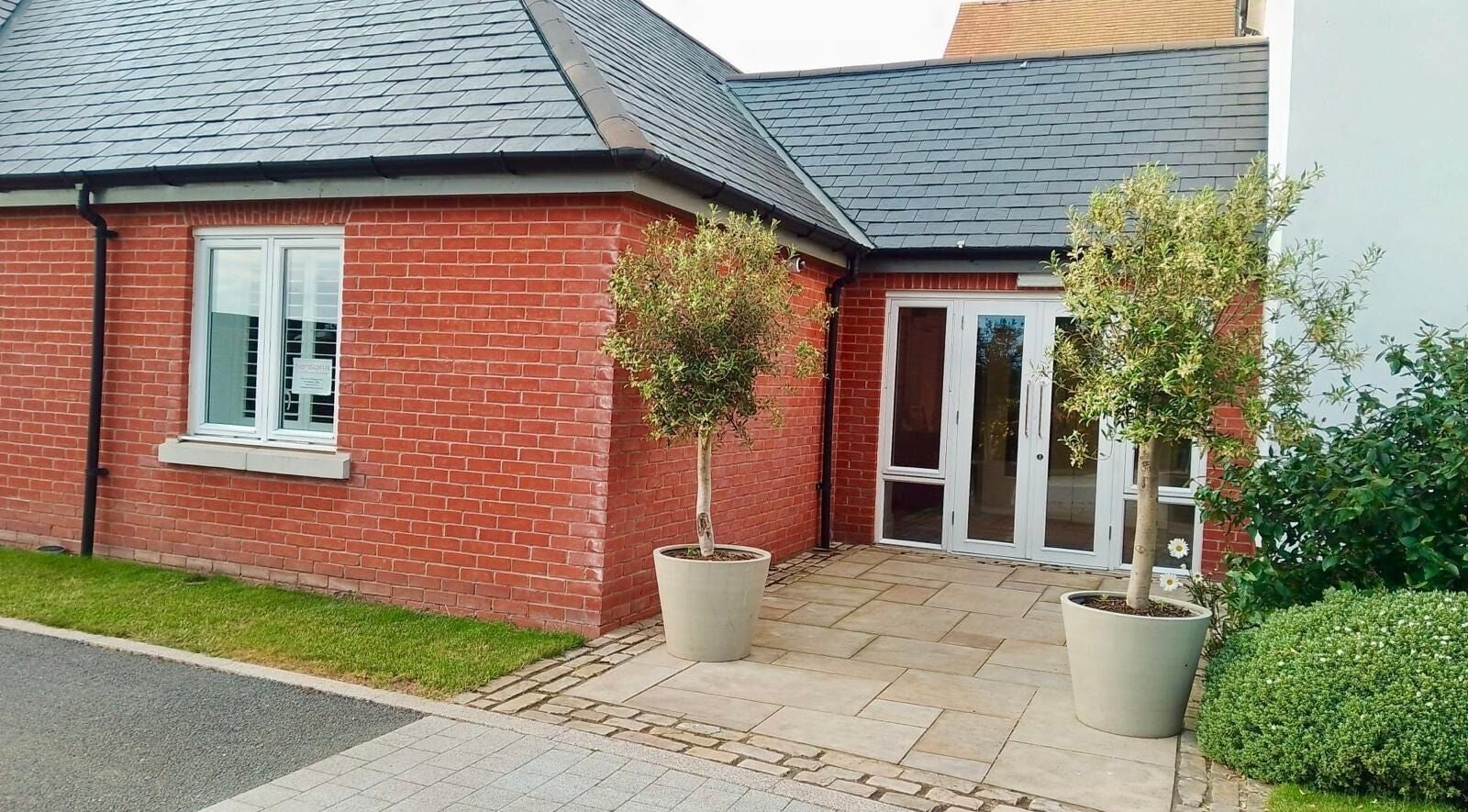 Gifford Lea entrance with red brick exterior and potted trees in Chester, England, GB.