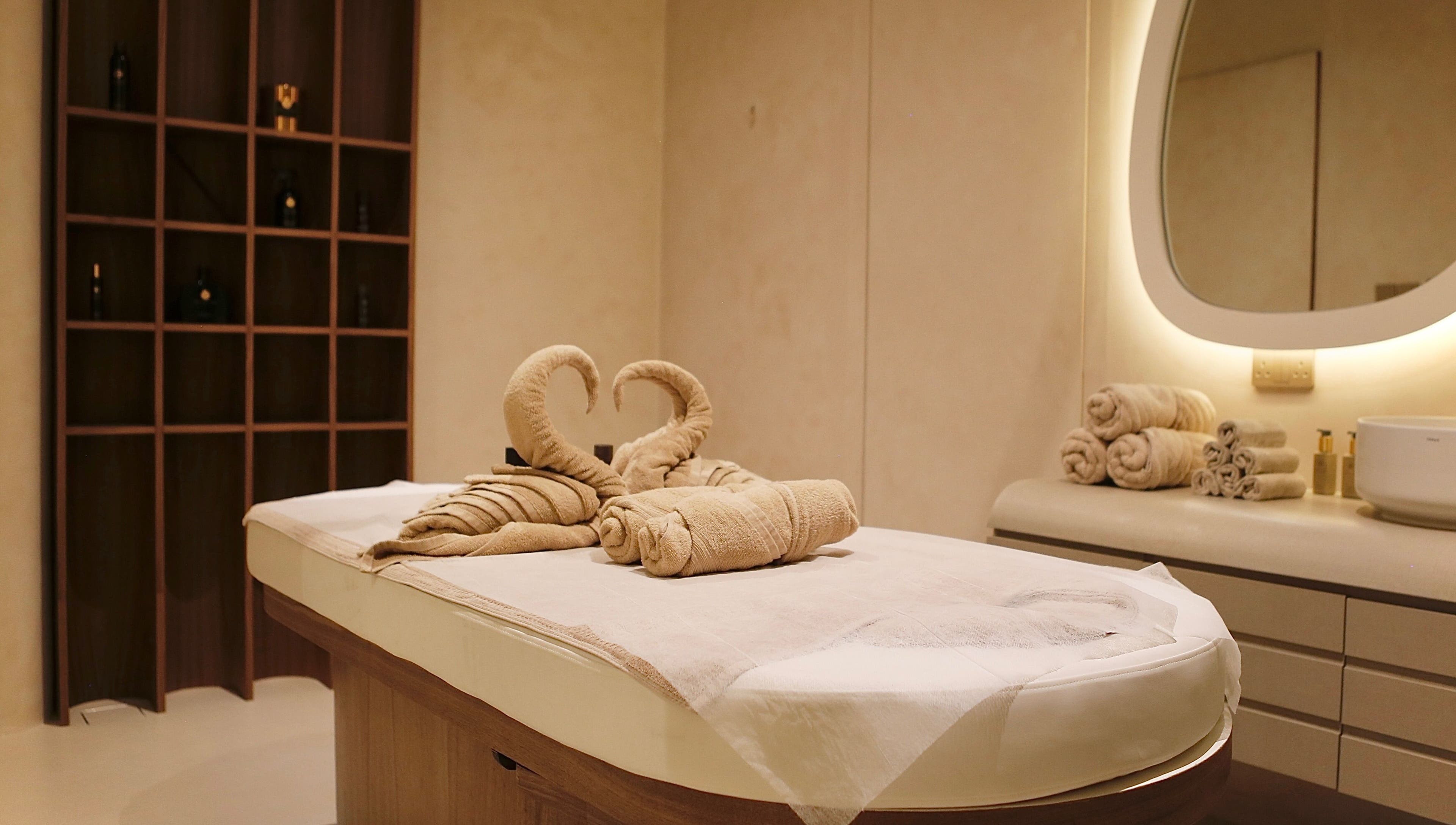 Luxurious massage table with towel swans at Calma Massage & Spa, Al-seef, Bahrain, BH.