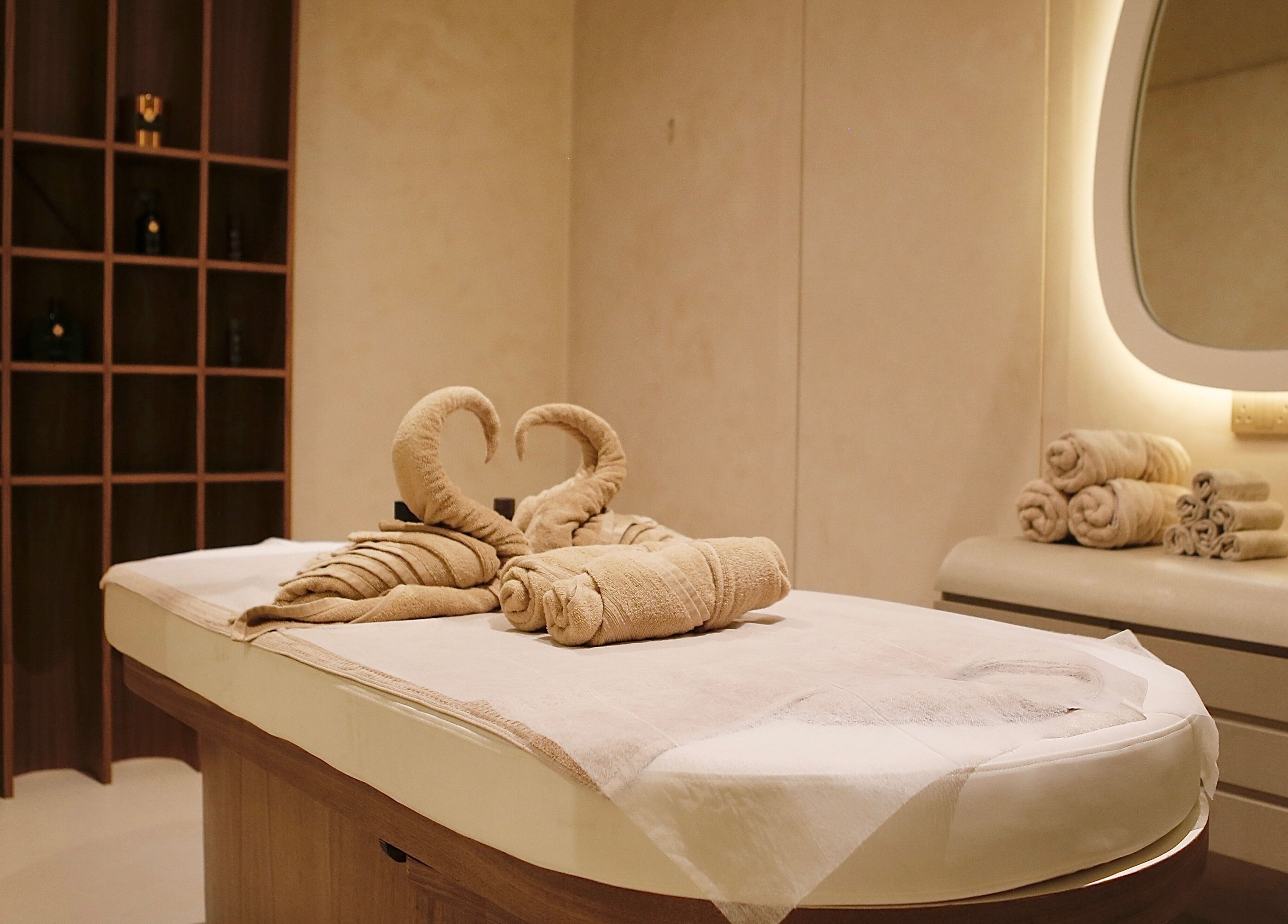 Luxurious massage table with towel swans at Calma Massage & Spa, Al-seef, Bahrain, BH.