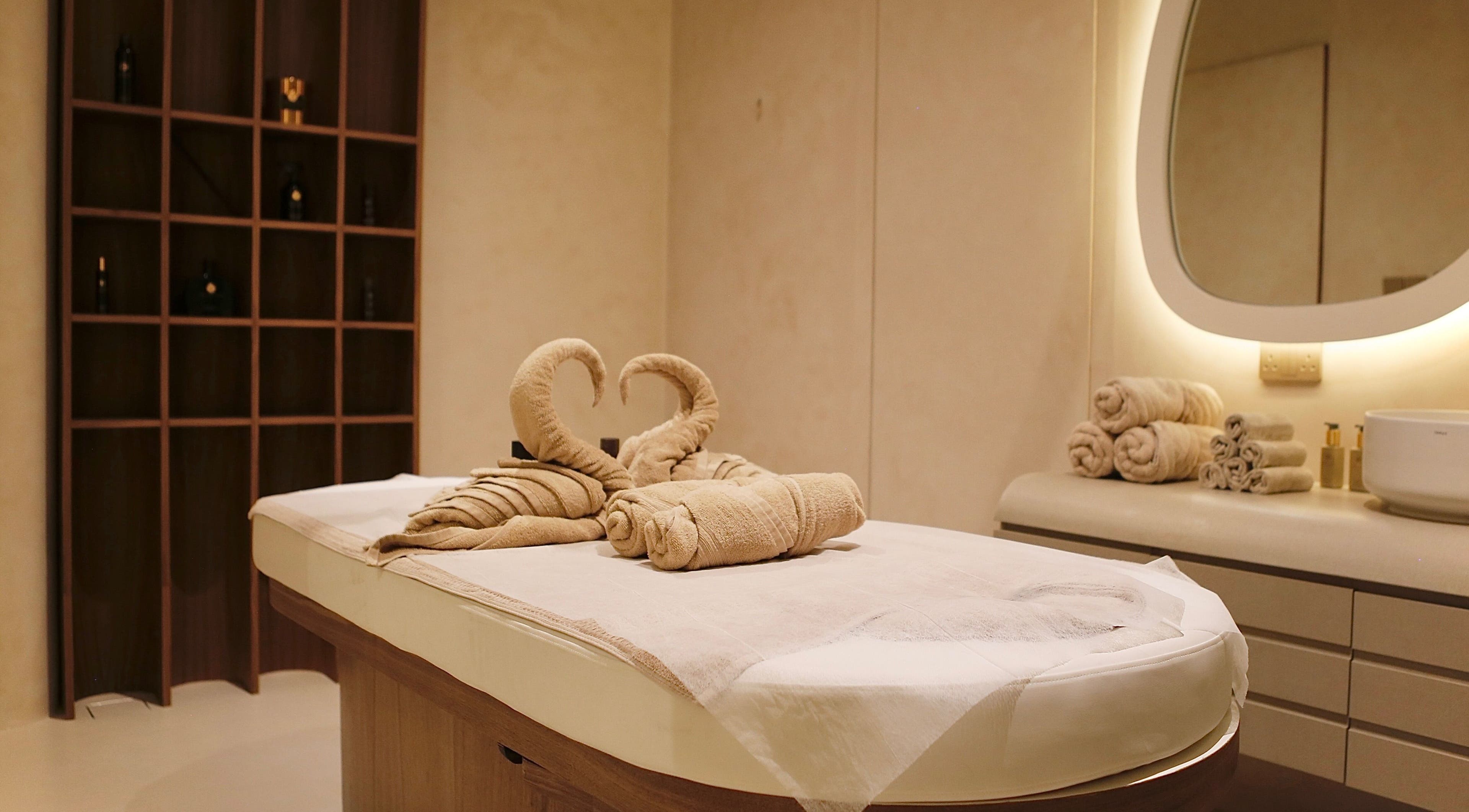 Luxurious massage table with towel swans at Calma Massage & Spa, Al-seef, Bahrain, BH.