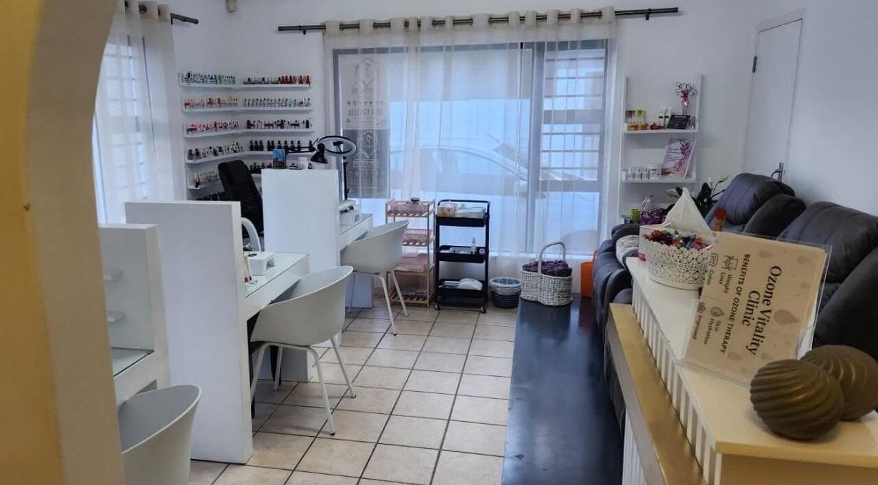 Inviting nail care corner at Flamingo Beauty House, Cape Town, Western Cape, ZA with stylish seating and decor.