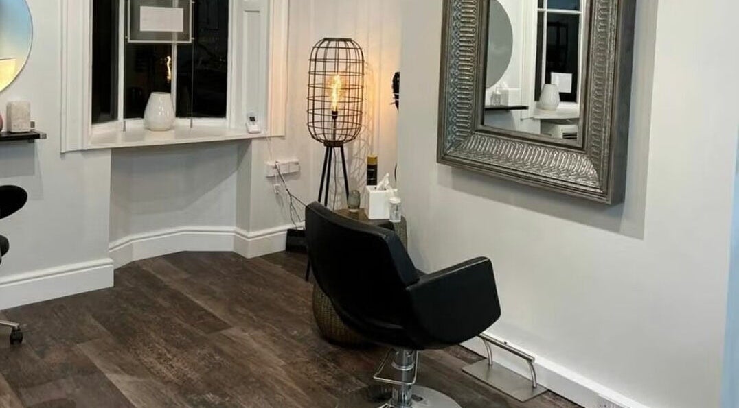 Elegant interior of Hair by Stacey in Stourbridge, England, GB featuring stylish chair and large mirror.