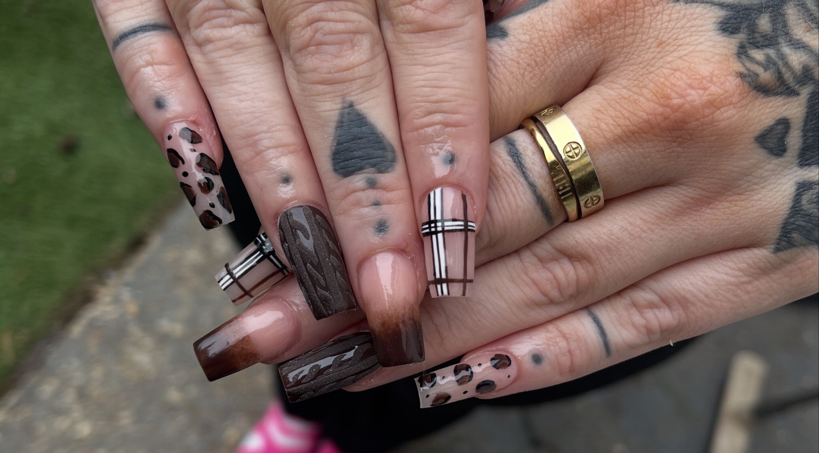 Stylish nail art at Alyssia-Ellen's Beauty, Bordon, England, GB, featuring creative brown and plaid designs.
