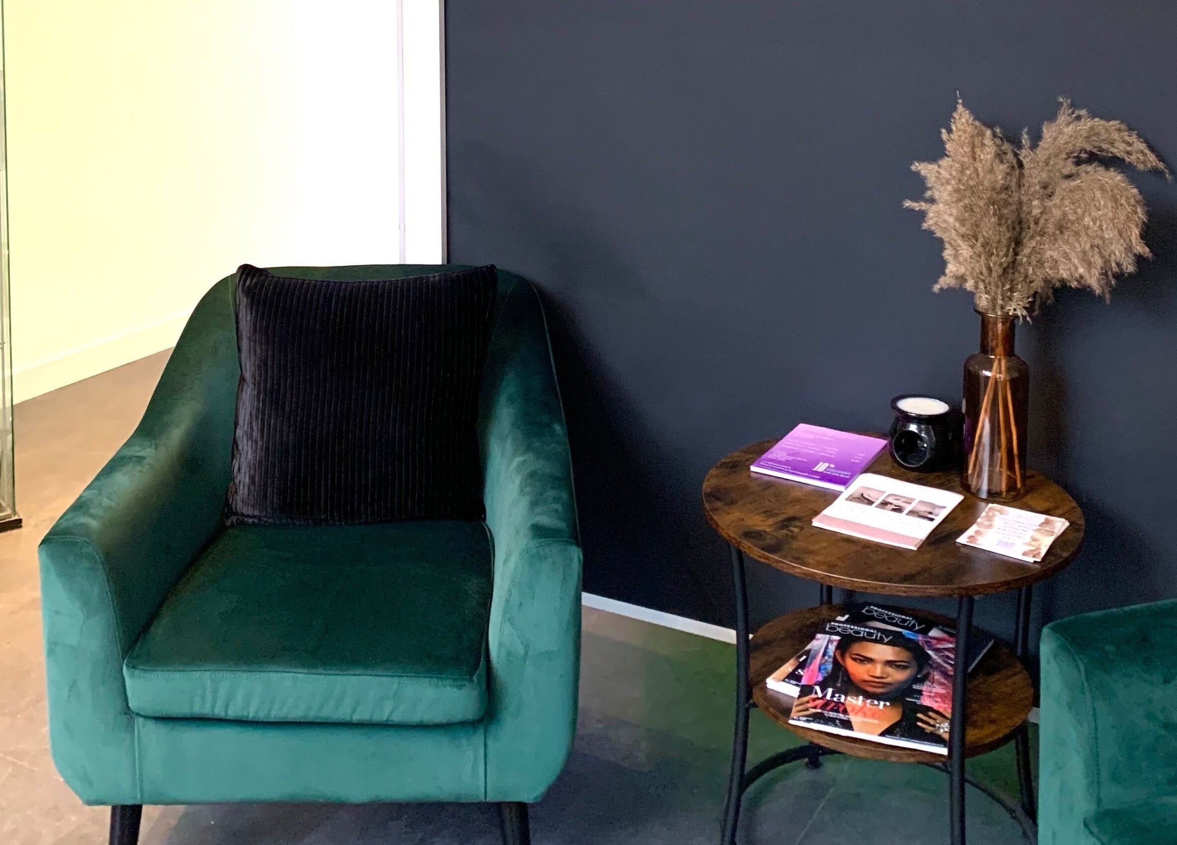 Inviting lounge at Glow Tanning and Beauty in Chelmsford, England, GB with plush chairs and table decor.