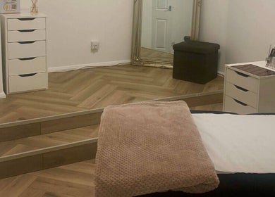 Cozy treatment room at Glow Tanning and Beauty, Chelmsford, England, GB, with mirror and soft furnishings.