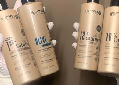 Glow Tanning and Beauty in Chelmsford, England, showcases premium tanning products in stylish bottles.