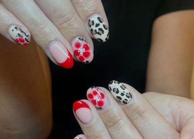 Stylish nail art with floral and leopard designs at Glow Tanning and Beauty, Chelmsford, England, GB.