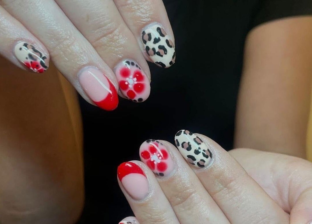 Stylish nail art with floral and leopard designs at Glow Tanning and Beauty, Chelmsford, England, GB.