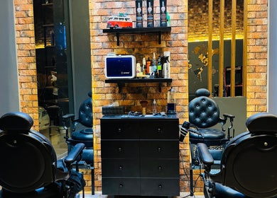 Modern barber chairs and grooming products at BOLD Men’s Salon, Dubai, Dubai, AE. Stylish, inviting interior.
