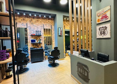 Interior of BOLD Men’s Salon in Dubai, featuring vintage decor and modern barber chairs.