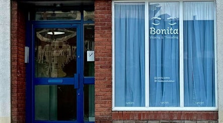Entrance of BONITA Beauty Therapy in Guildford, England, GB with blue door and curtains.