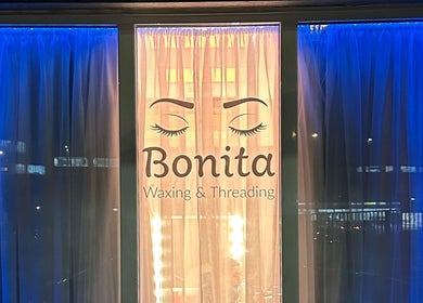 Exterior display of BONITA Beauty Therapy in Guildford, England, GB, showcasing elegant waxing and threading signage.