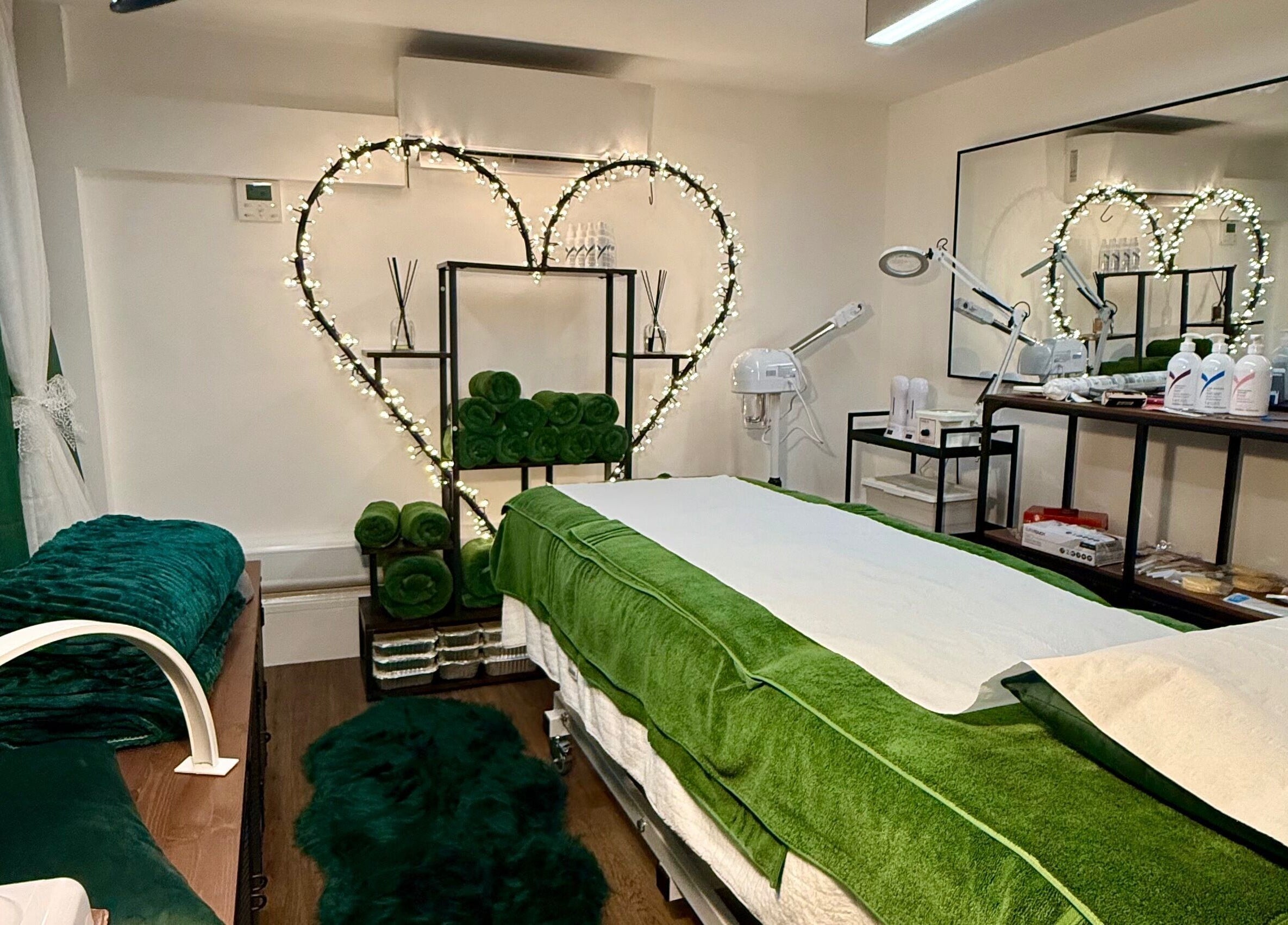 Calming spa room at Spa by BONITA, Guildford, England, GB with green accents and cozy lighting.