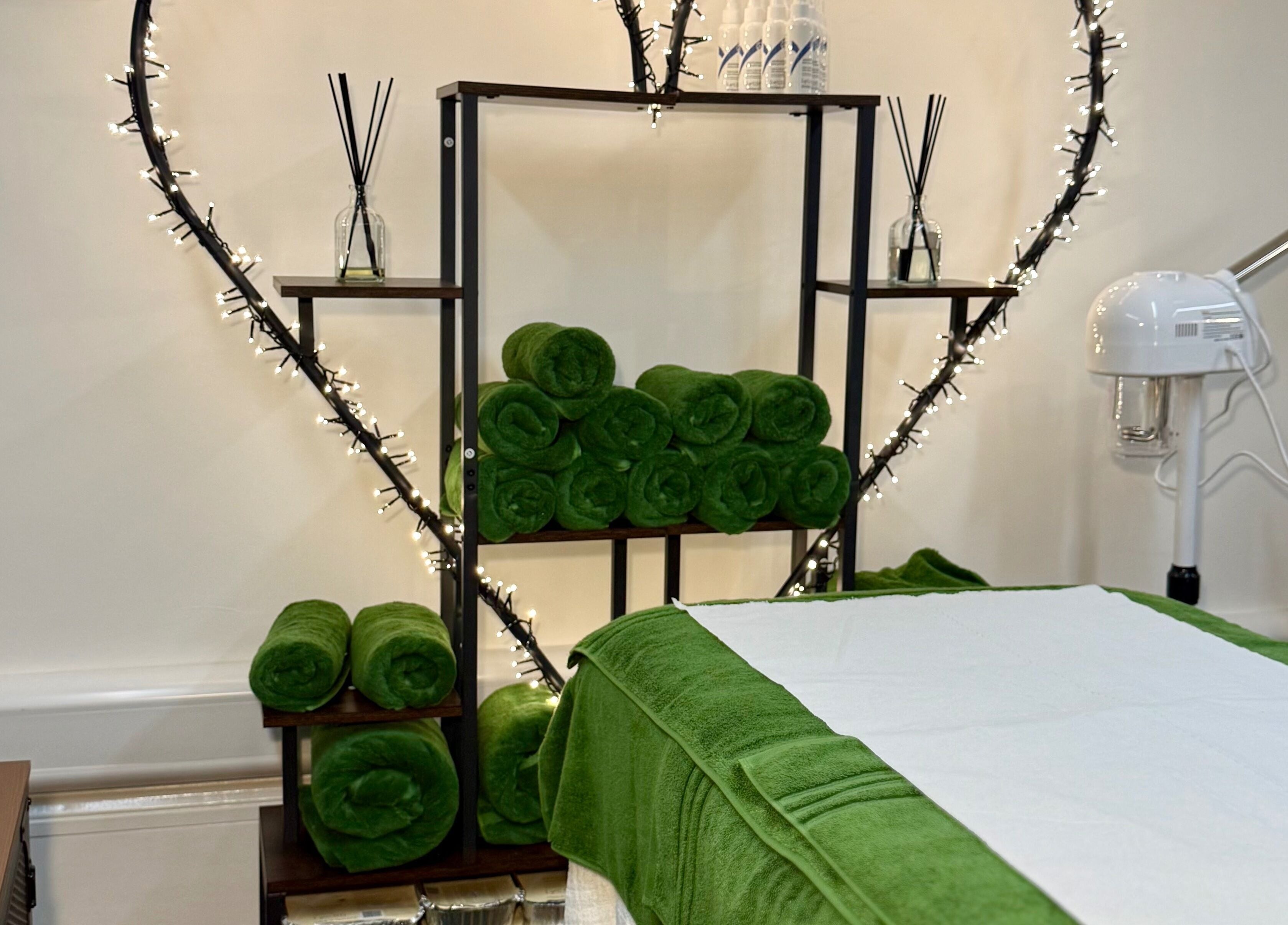 Relaxing spa room at Spa by BONITA, Guildford, England, GB with green towels and calming decor.