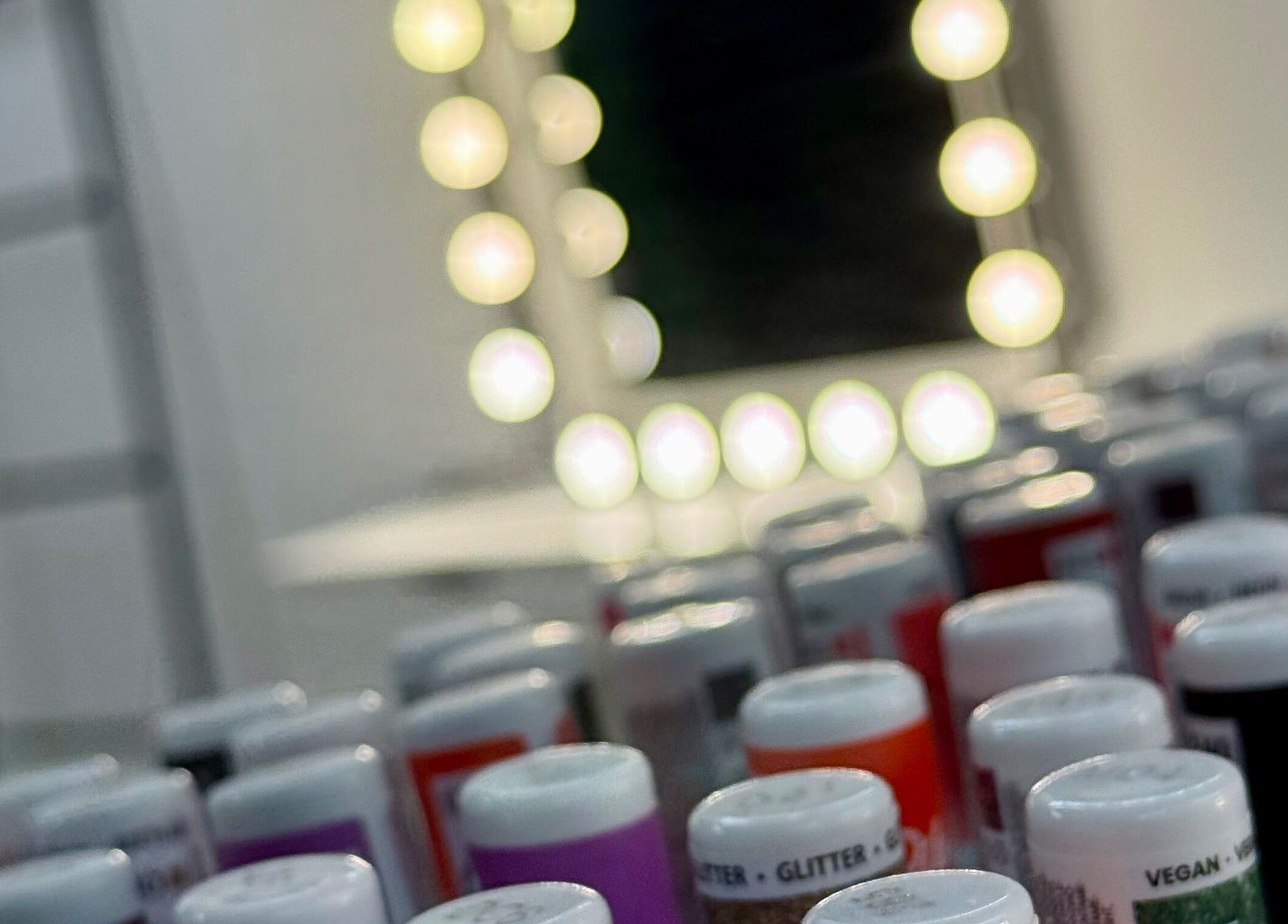 Assorted nail polishes under elegant vanity lights at Spa by BONITA, Guildford, England, GB.