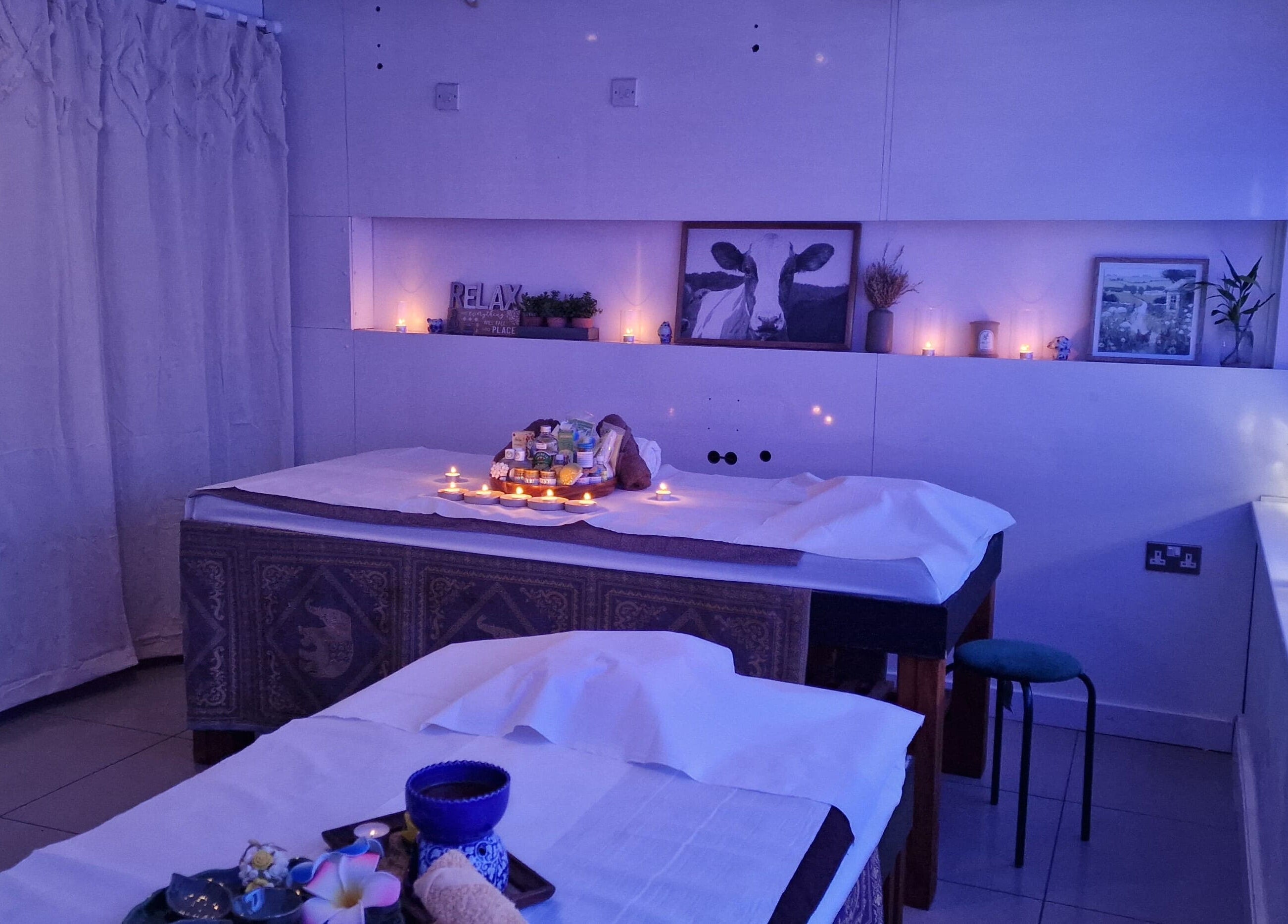 Panlaan Spa massage room with candles and relaxing decor in Weymouth, England, GB.