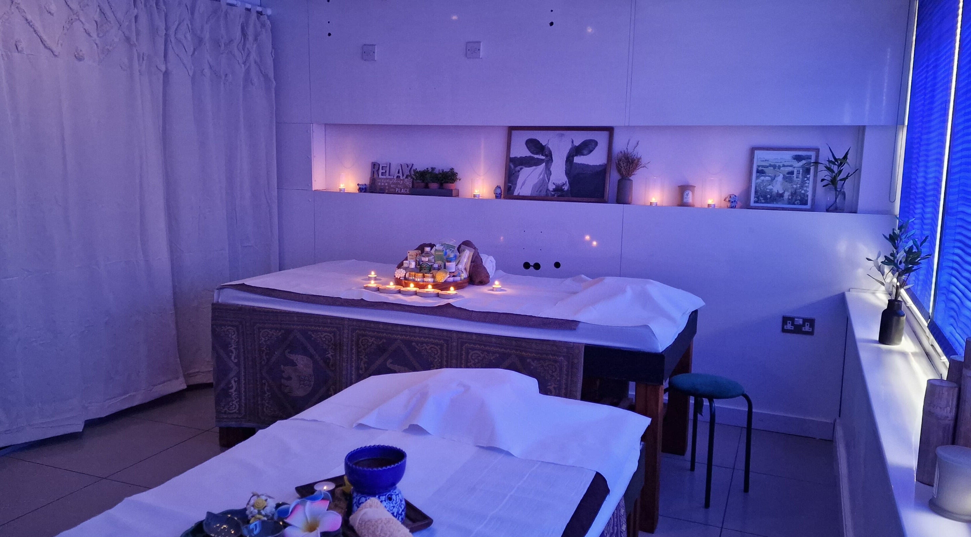 Panlaan Spa massage room with candles and relaxing decor in Weymouth, England, GB.