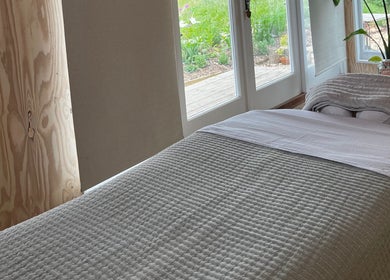 Tranquil massage room at Wild Coast Wellbeing, Kings Lynn, England, GB with natural light and cozy decor.