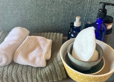 Spa essentials at Wild Coast Wellbeing, Kings Lynn, England, GB. Towels and bottles arranged neatly.
