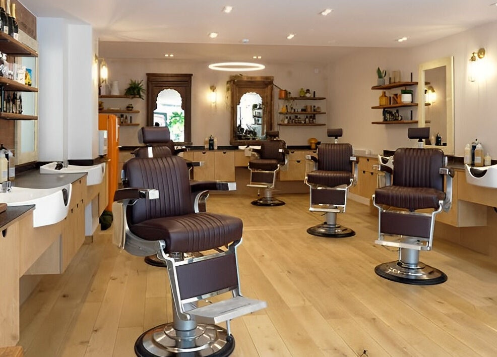 Modern salon interior at time. in London, England, GB, featuring elegant styling chairs and sleek wooden decor.