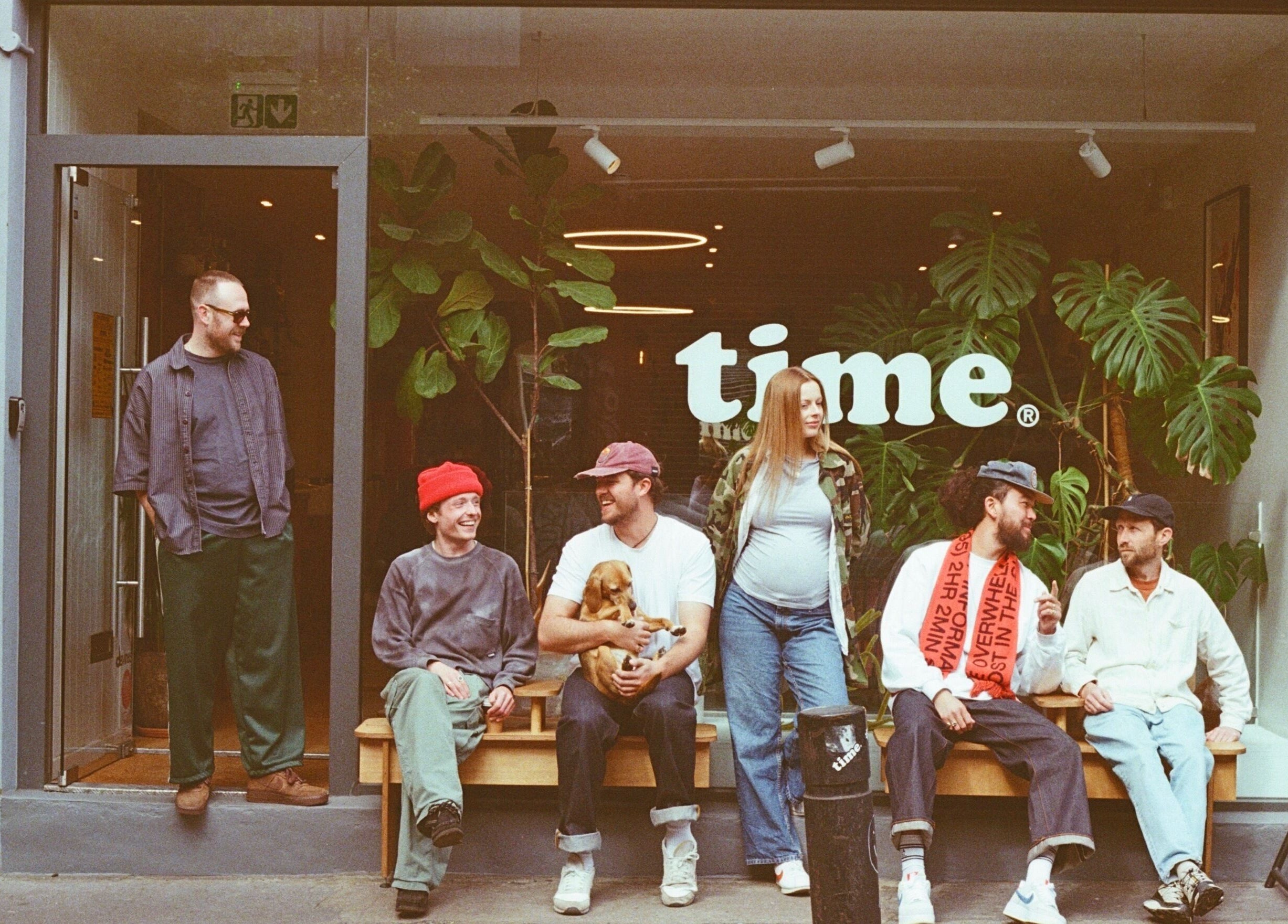 Group enjoying vibrant atmosphere at time. venue, London, England, GB, with cozy outdoor seating.