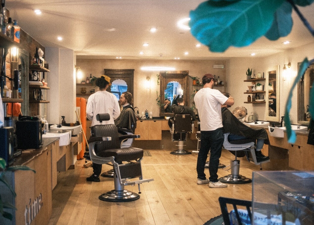 Stylish salon interior at time. in London, England, GB with clients enjoying hair services.