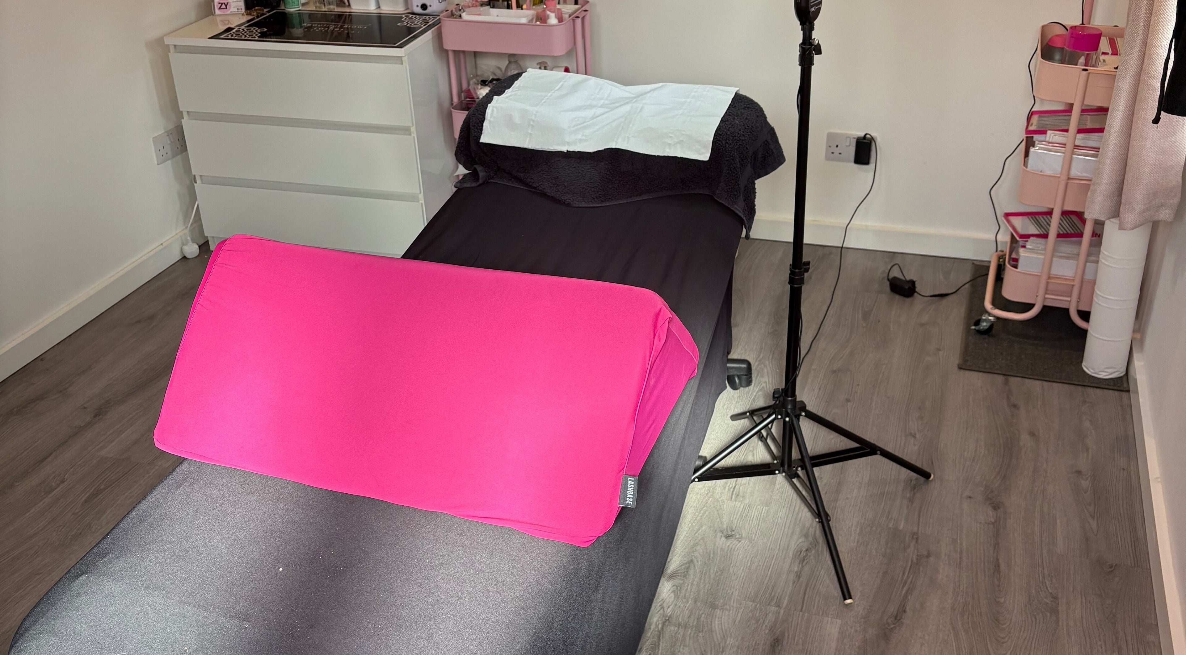 A cozy treatment bed with pink cushion at Zy beauty, St Austell, England, GB. Ideal for relaxation and rejuvenation.