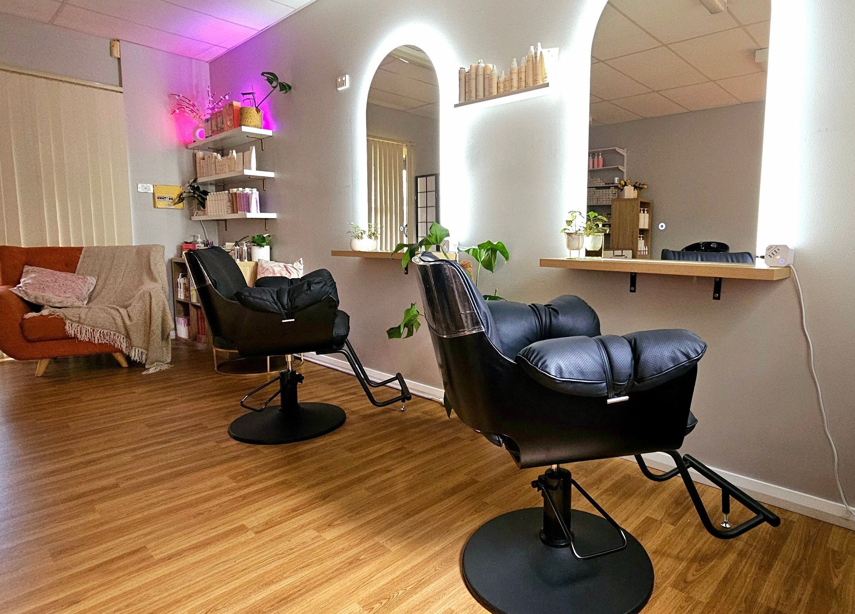 Chic interior of Hair By Hayley, Milpara, Western Australia, AU, featuring sleek styling chairs and cozy seating.