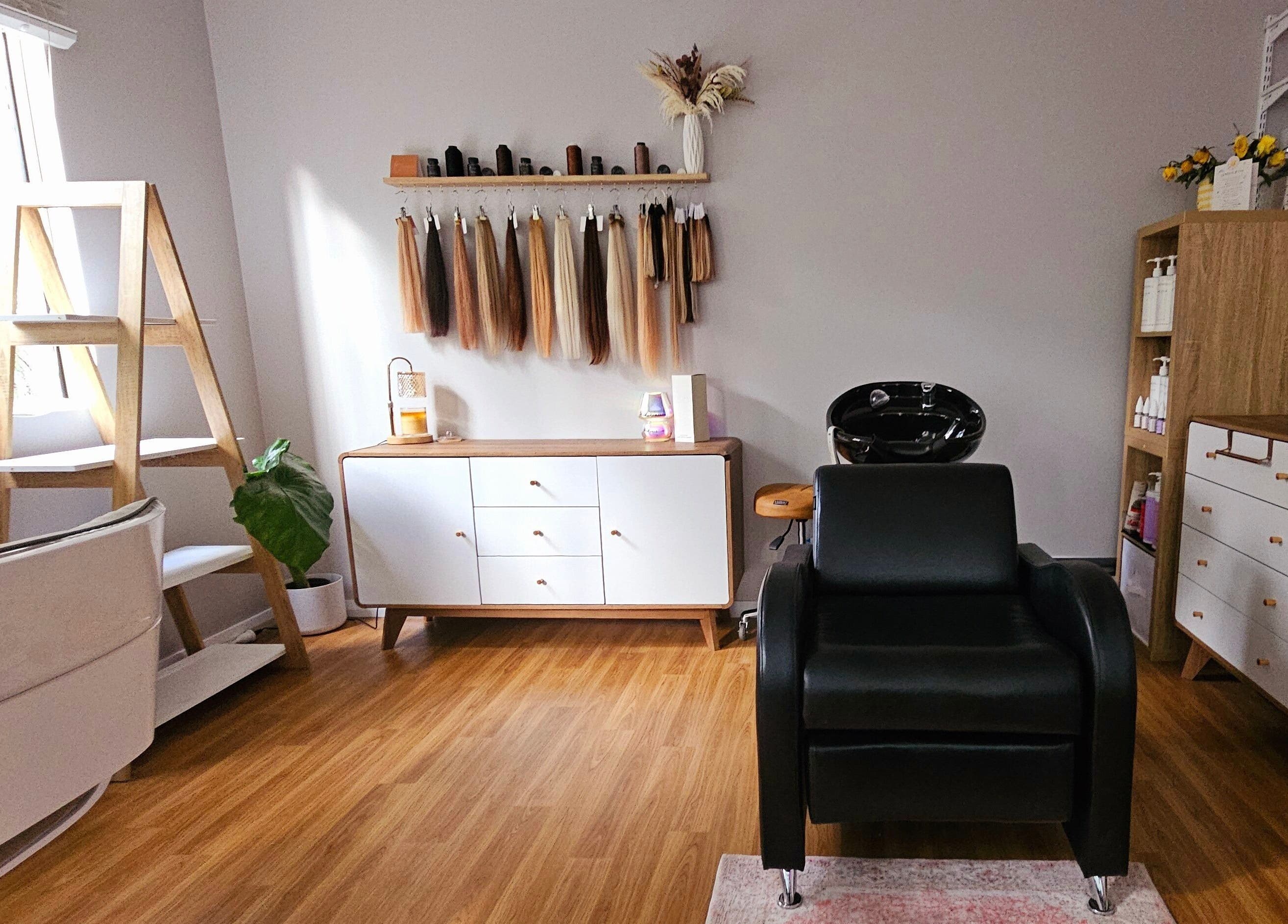 Elegant salon interior at Hair By Hayley in Milpara, Western Australia, AU with styling chair and product displays.