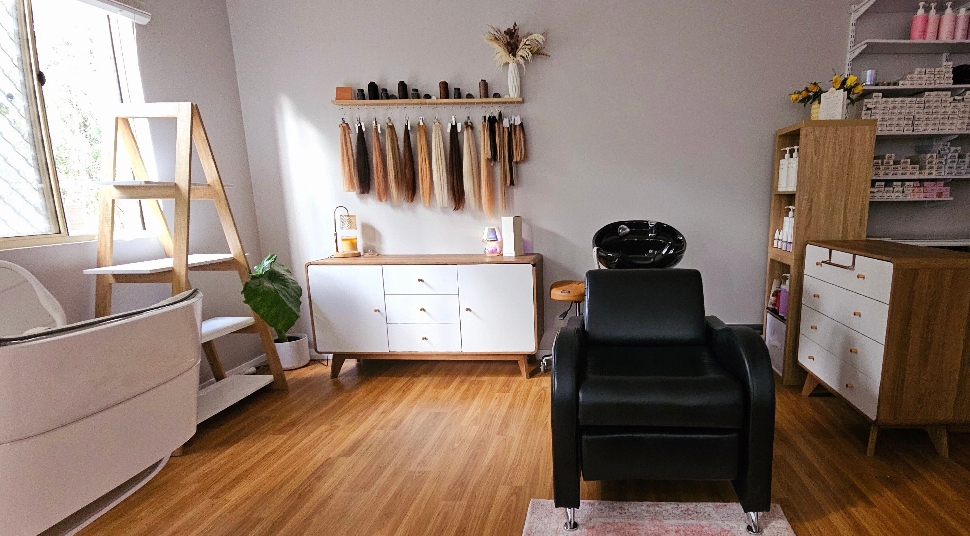 Elegant salon interior at Hair By Hayley in Milpara, Western Australia, AU with styling chair and product displays.