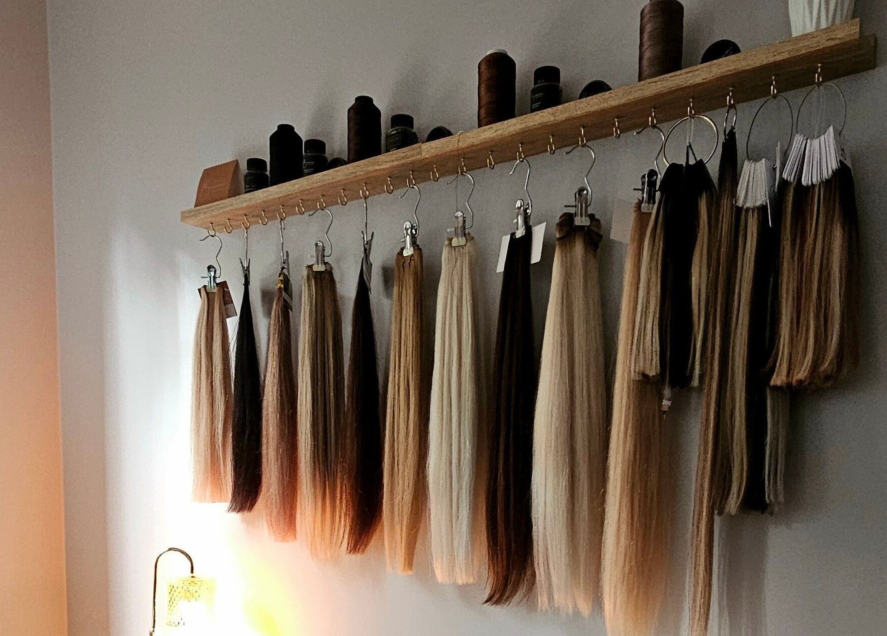Hair By Hayley's extension display in Milpara, Western Australia, showcasing diverse hair colors and textures.