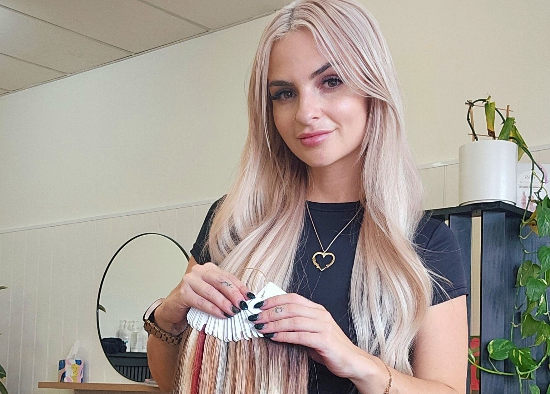 Hair stylist at Hair By Hayley in Milpara, Western Australia, showcasing hair color samples.