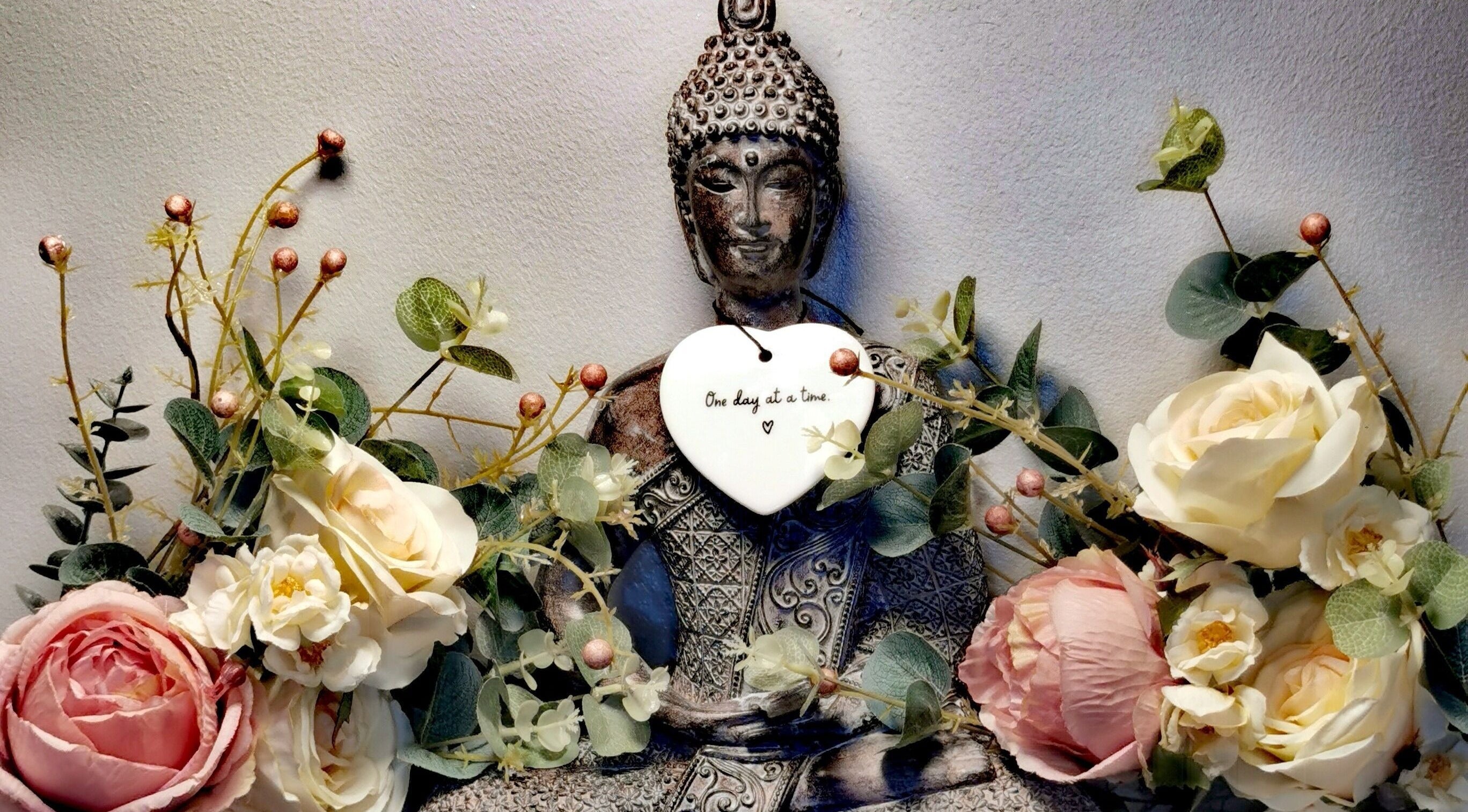 Tranquil Buddha with flowers at SB Beauty, Bangor, Northern Ireland, GB for serene ambiance.